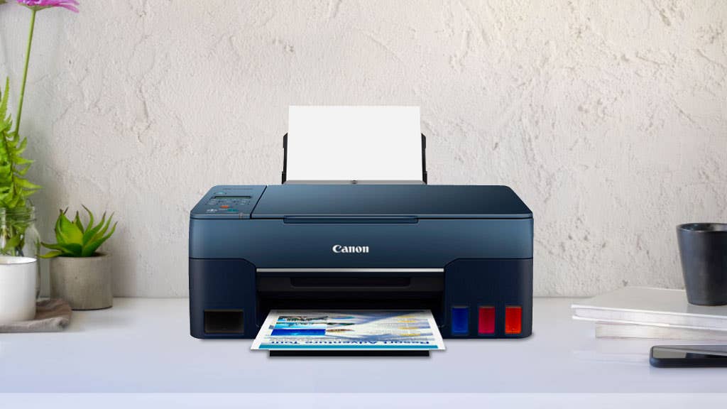 Photo of a black Canon printer on a white desk