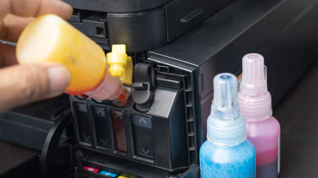 Person refilling ink cartridges of a printer