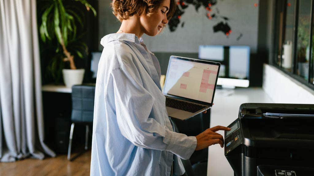 photo of a woman using a printer