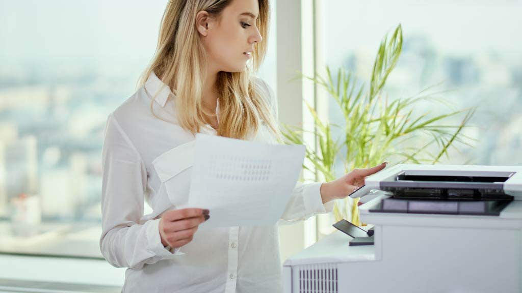 Woman using a white printer