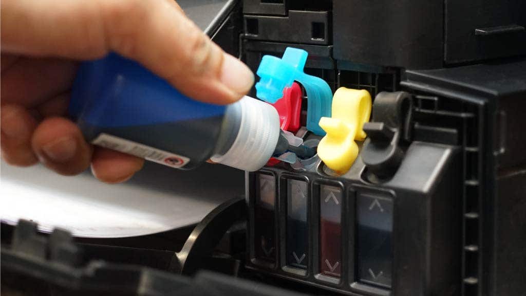Person refilling ink tank cartridges
