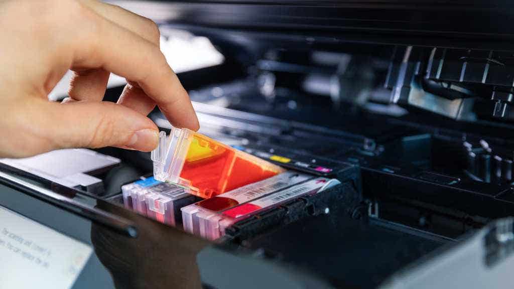 photo of a person replacing printer cartridges