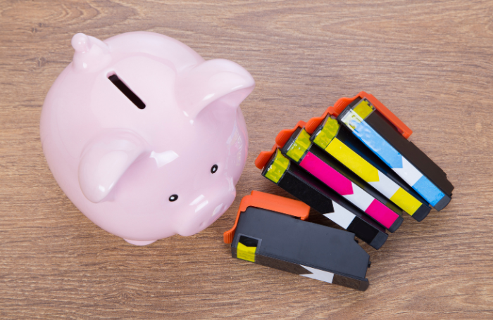 piggy bank next to printer ink cartridges