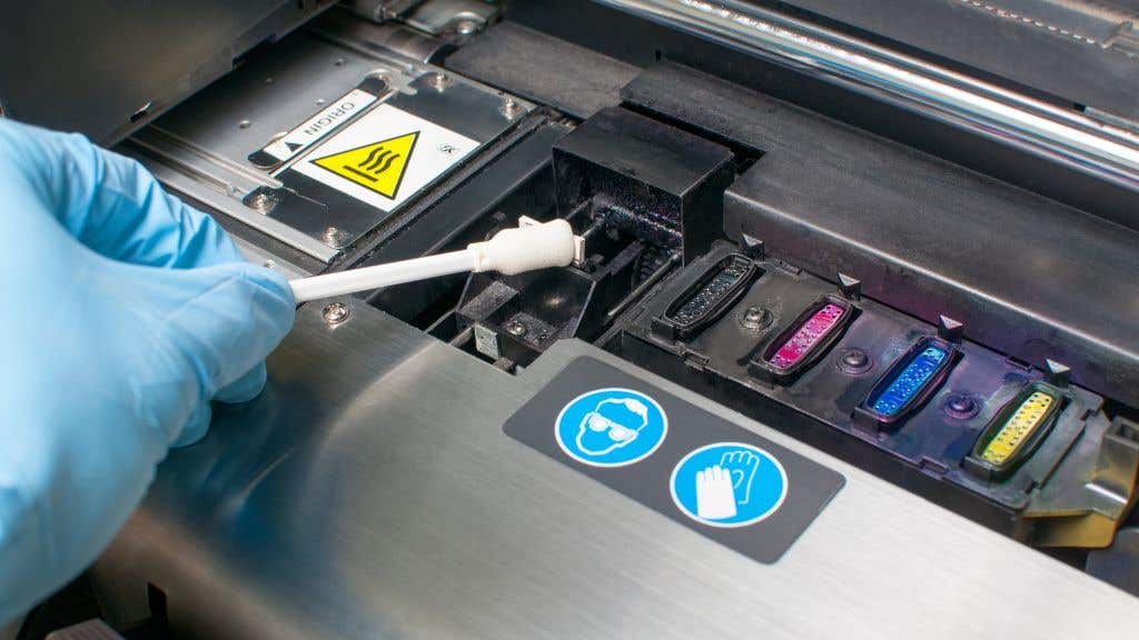 Person cleaning a printer