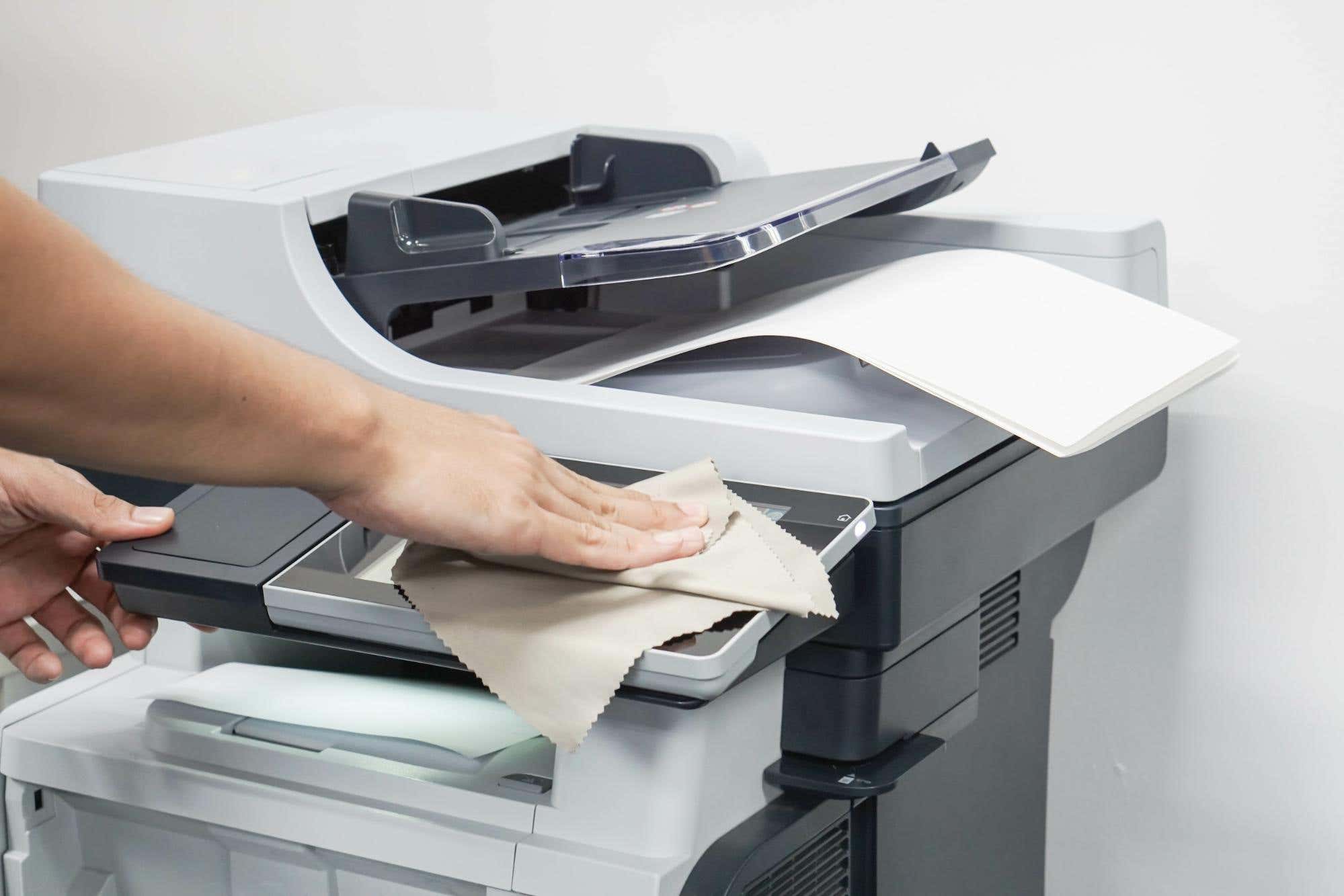 Office printer being cleaned
