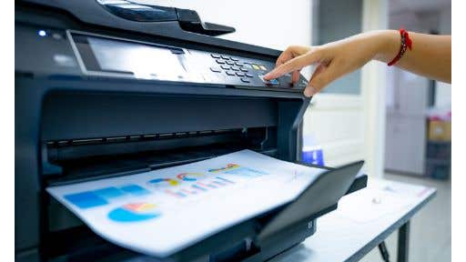 person using a black office printer