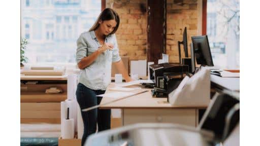 woman using a printer in an office