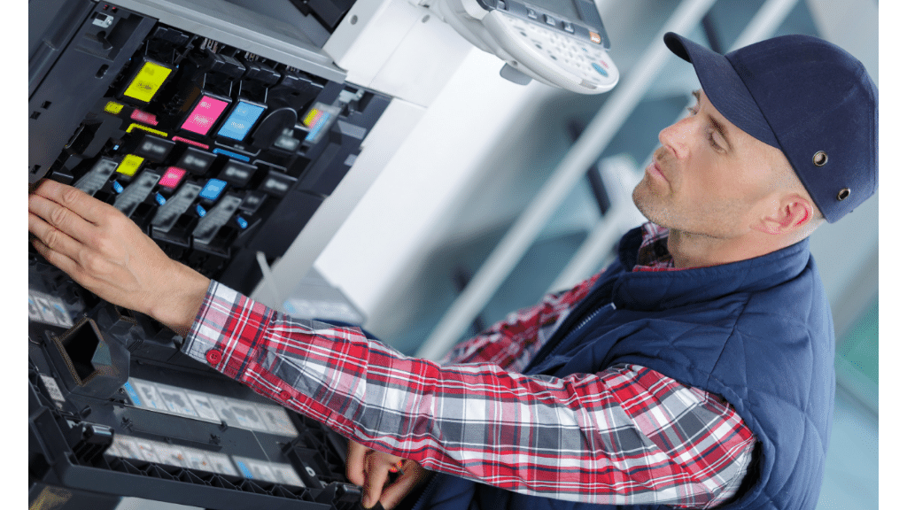 technician fixing a printer