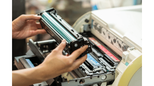 person replacing a printer toner cartridge