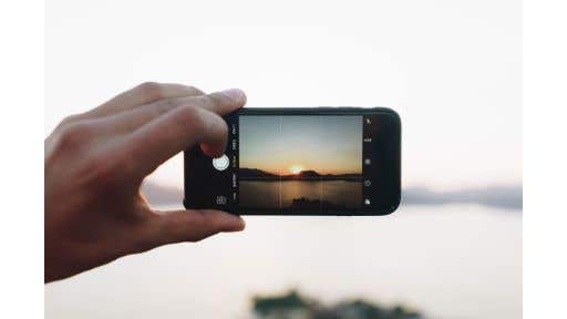person taking photo with their cellphone