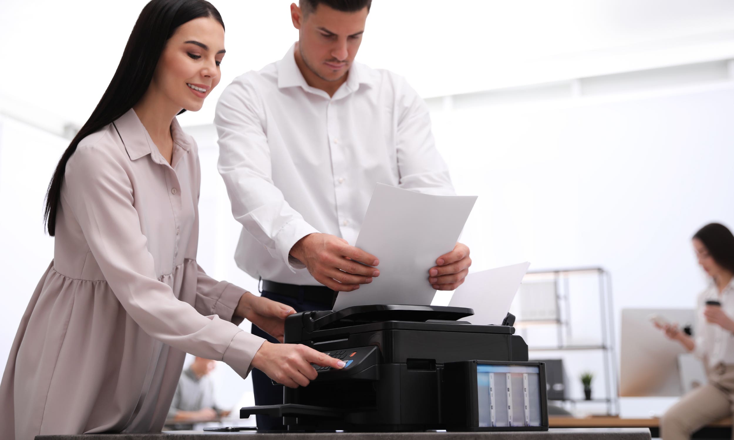man and woman sharing a printer