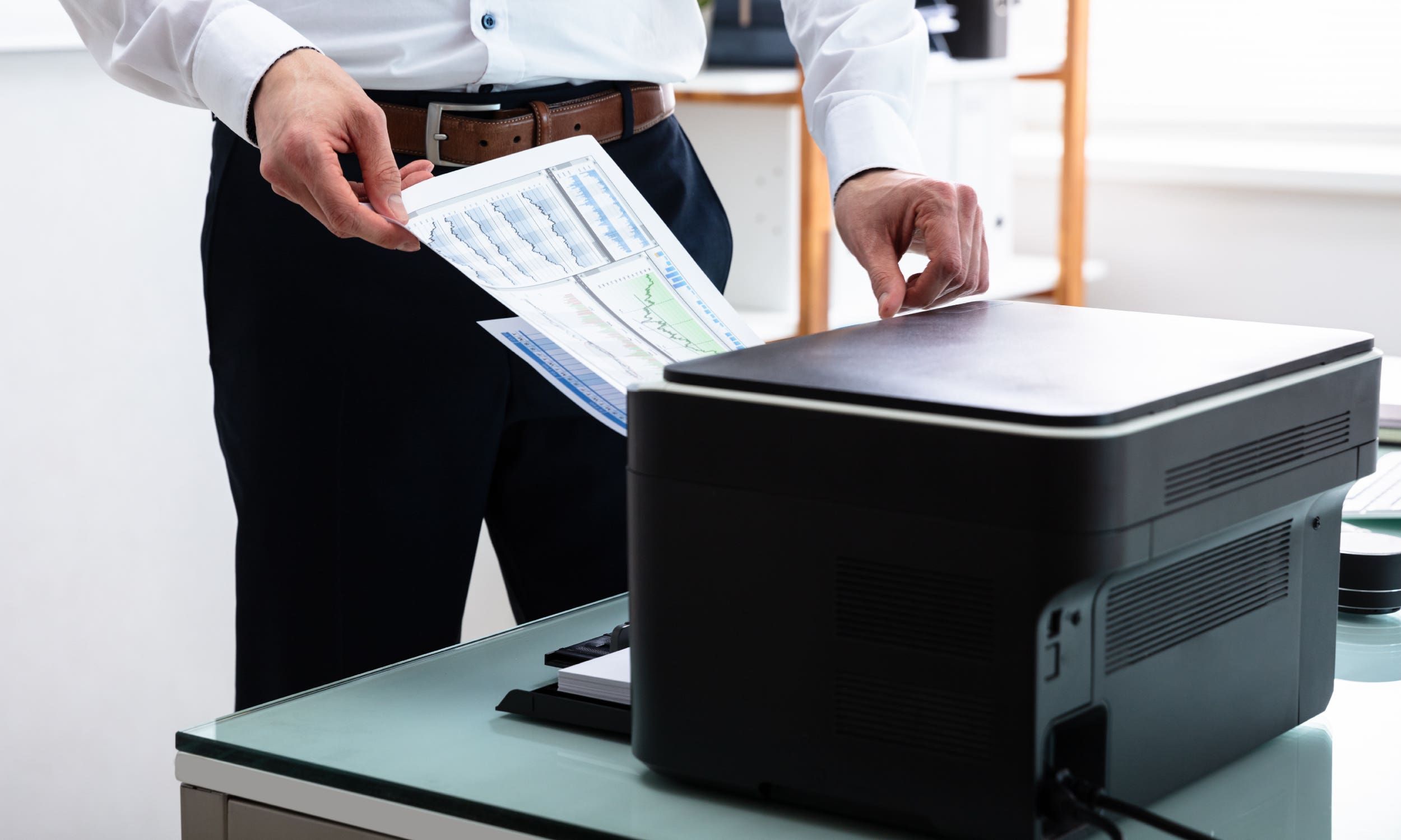 man retrieving printouts
