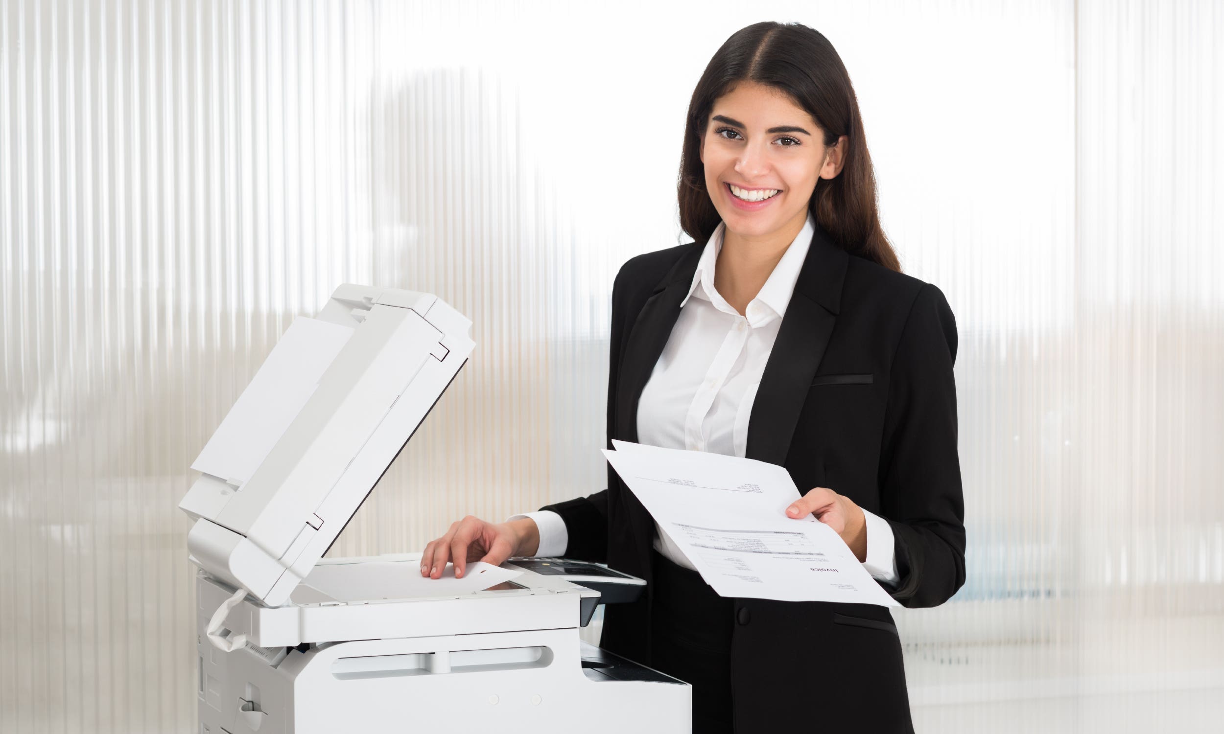 woman retrieving printouts
