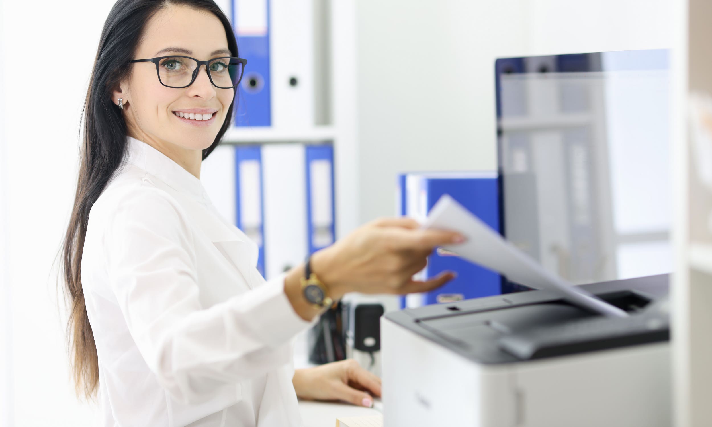 woman in white shirt using printer