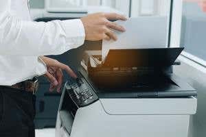 person using a printer in an office