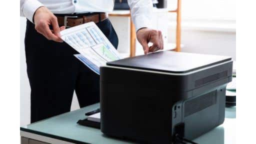 man using black desktop printer