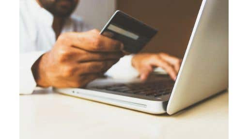 person using credit card to buy online