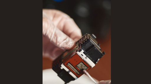 person cleaning a removable printhead manually