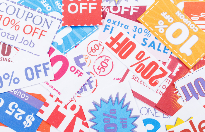 The image is a collage of various discount coupons with large text such as "50% OFF," "SALE," and other promotional offers, representing savings and deals.