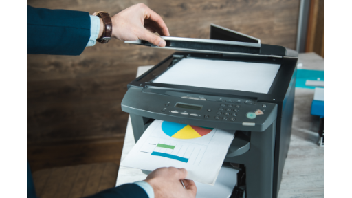 InkJets BLOG - Person printing a document on an office printer Person printing a color document on a office printer