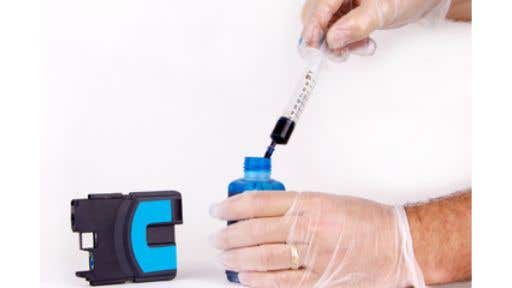 man_refilling_printer_ink_cartridges