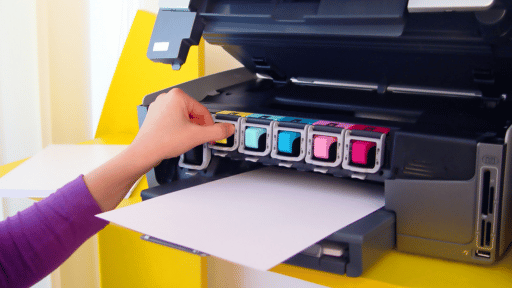 Person replacing ink cartridges from a printer