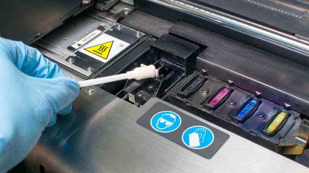 Person cleaning a printhead