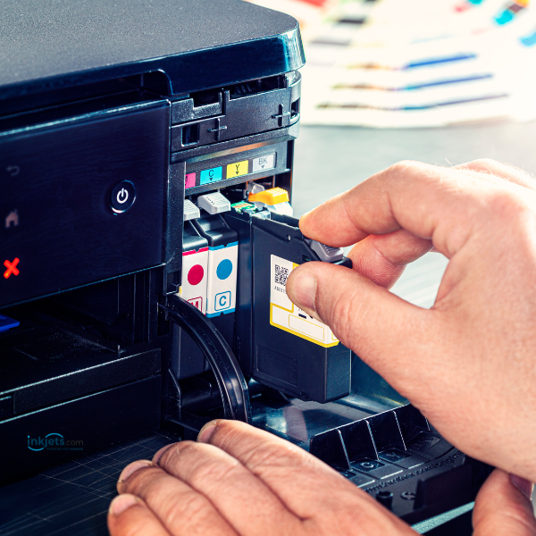 person replacing printer ink
