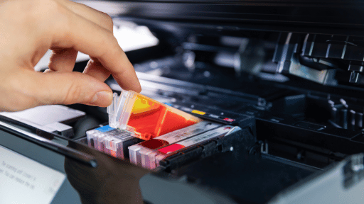 Person replacing a printer ink cartridge